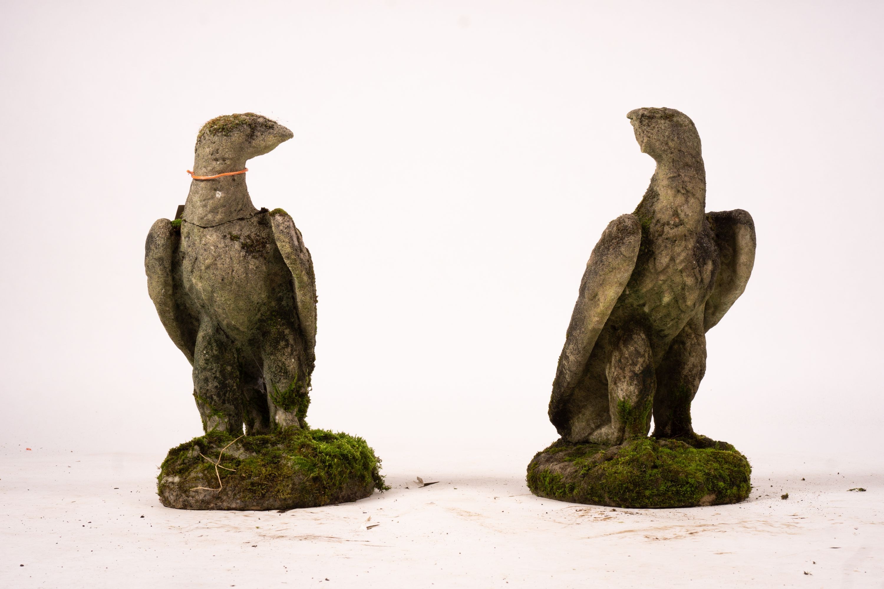 A pair of weathered reconstituted stone eagle garden ornaments, H.54cm